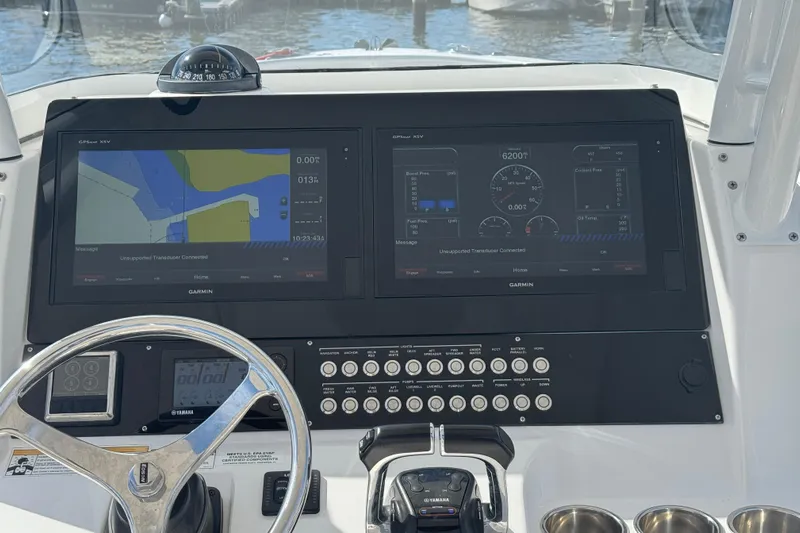 Lady Grey Yacht Photos Pics Dashboard of a 2016 Edgewater 320CC boat with Garmin navigation displays.