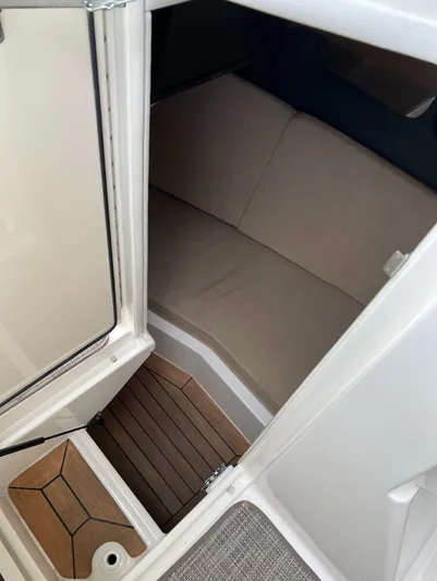  Yacht Photos Pics Interior cabin of 2016 Sea Ray 350 SLX with beige seating and wooden flooring.