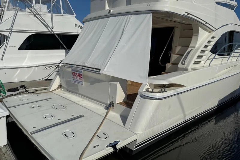  Yacht Photos Pics 2009 Ovation 52 yacht for sale, docked with covered deck and visible "For Sale" sign.