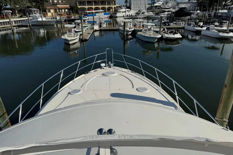  Yacht Photos Pics Bow view of 2009 Ovation 52 yacht docked in a marina with surrounding boats.