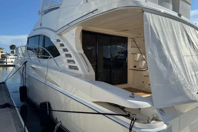  Yacht Photos Pics Luxury 2009 Ovation 52 yacht docked at marina, featuring sleek design and spacious deck.