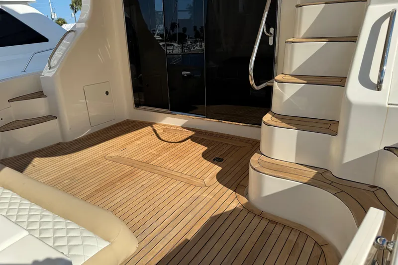  Yacht Photos Pics Luxurious 2009 Ovation 52 yacht deck with wooden flooring and elegant stairs.