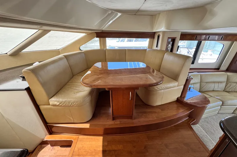  Yacht Photos Pics Luxurious 2009 Ovation 52 yacht interior with leather seating and wooden table.