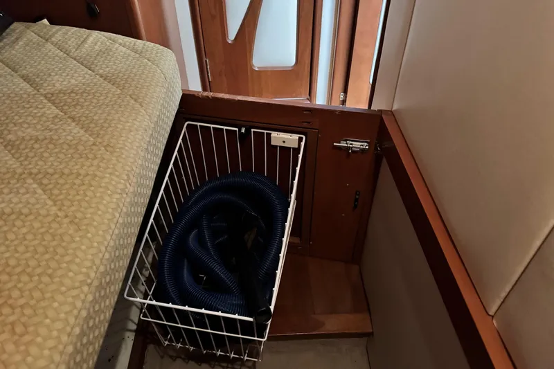  Yacht Photos Pics Storage compartment with coiled hose in 2009 Ovation 52 yacht interior.