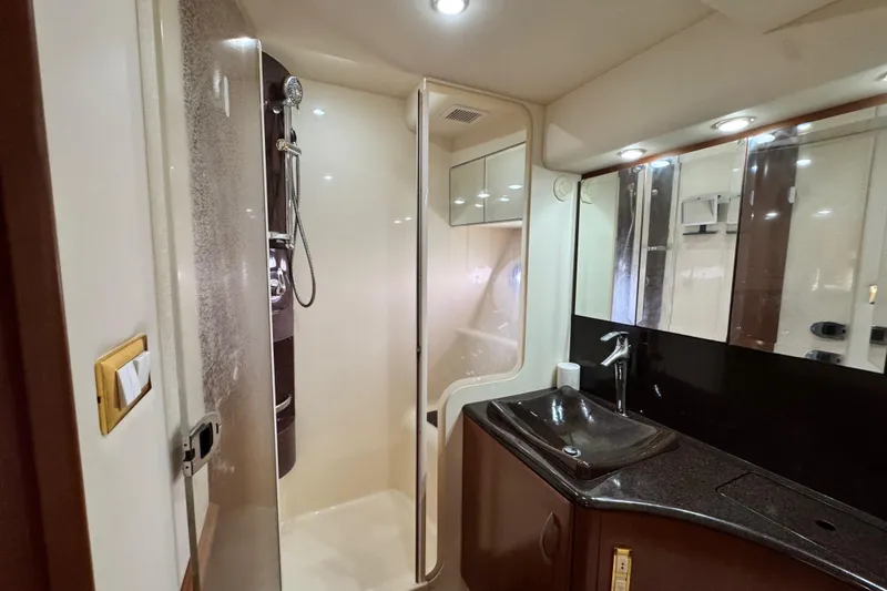  Yacht Photos Pics Luxurious bathroom in 2009 Ovation 52 yacht with modern shower and sleek sink design.