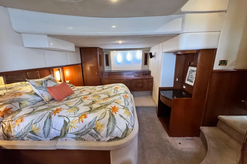  Yacht Photos Pics Luxurious 2009 Ovation 52 yacht bedroom with floral bedding and elegant wood accents.