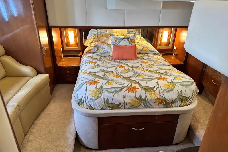  Yacht Photos Pics Luxurious 2009 Ovation 52 yacht bedroom with floral bedding and elegant wood accents.