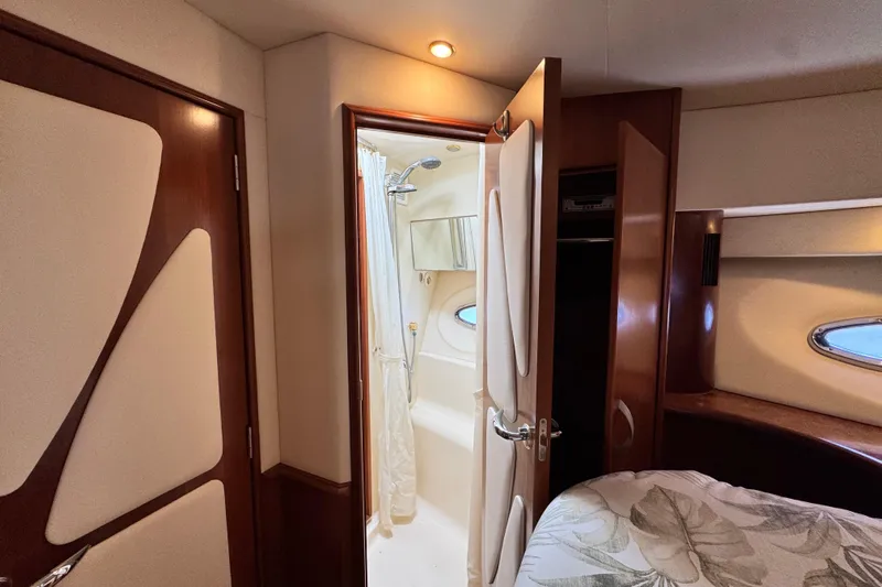  Yacht Photos Pics Luxurious interior of 2009 Ovation 52 yacht featuring a cozy bedroom and bathroom.