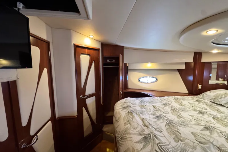  Yacht Photos Pics Luxurious 2009 Ovation 52 yacht bedroom with elegant wood finishes and modern lighting.