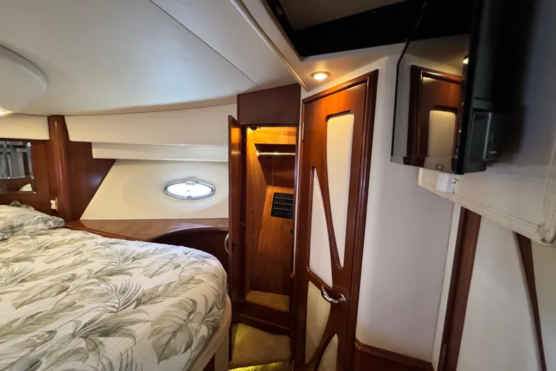  Yacht Photos Pics Luxurious 2009 Ovation 52 yacht interior with elegant wood finishes and cozy bedding.