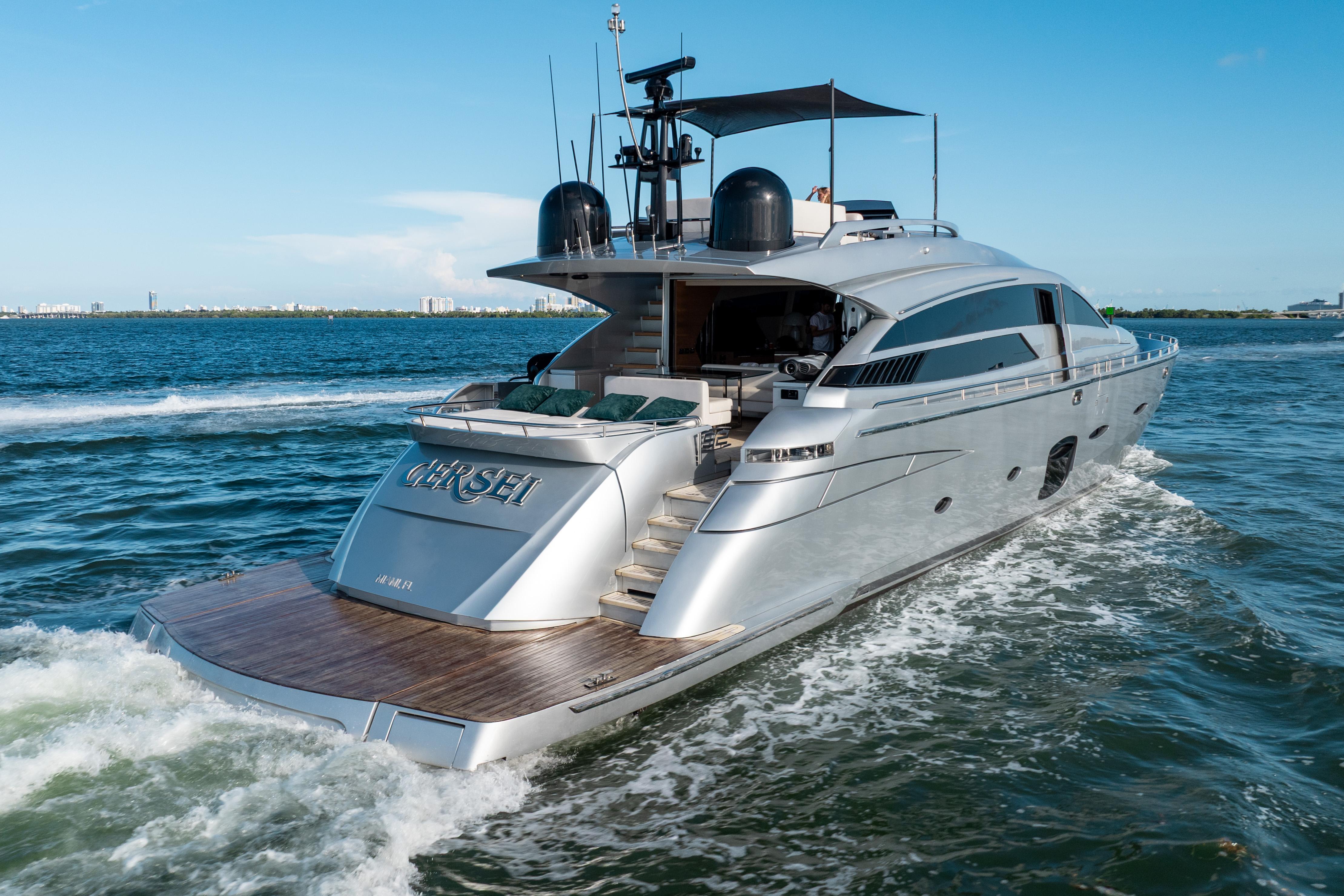 Luxurious 2012 Pershing 92 yacht cruising on open water under clear blue skies.