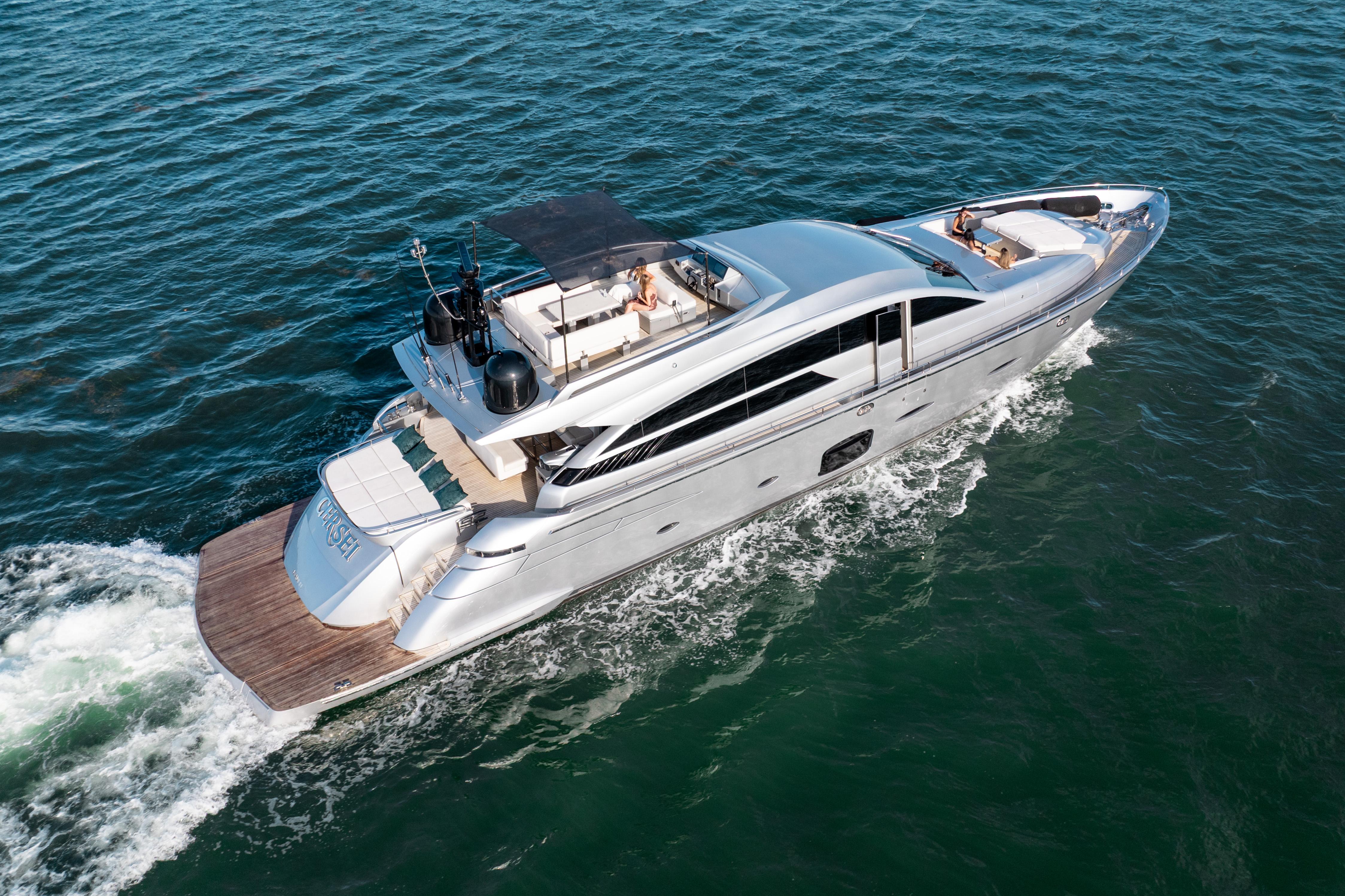 Luxury 2012 Pershing 92 yacht cruising on open water, aerial view.