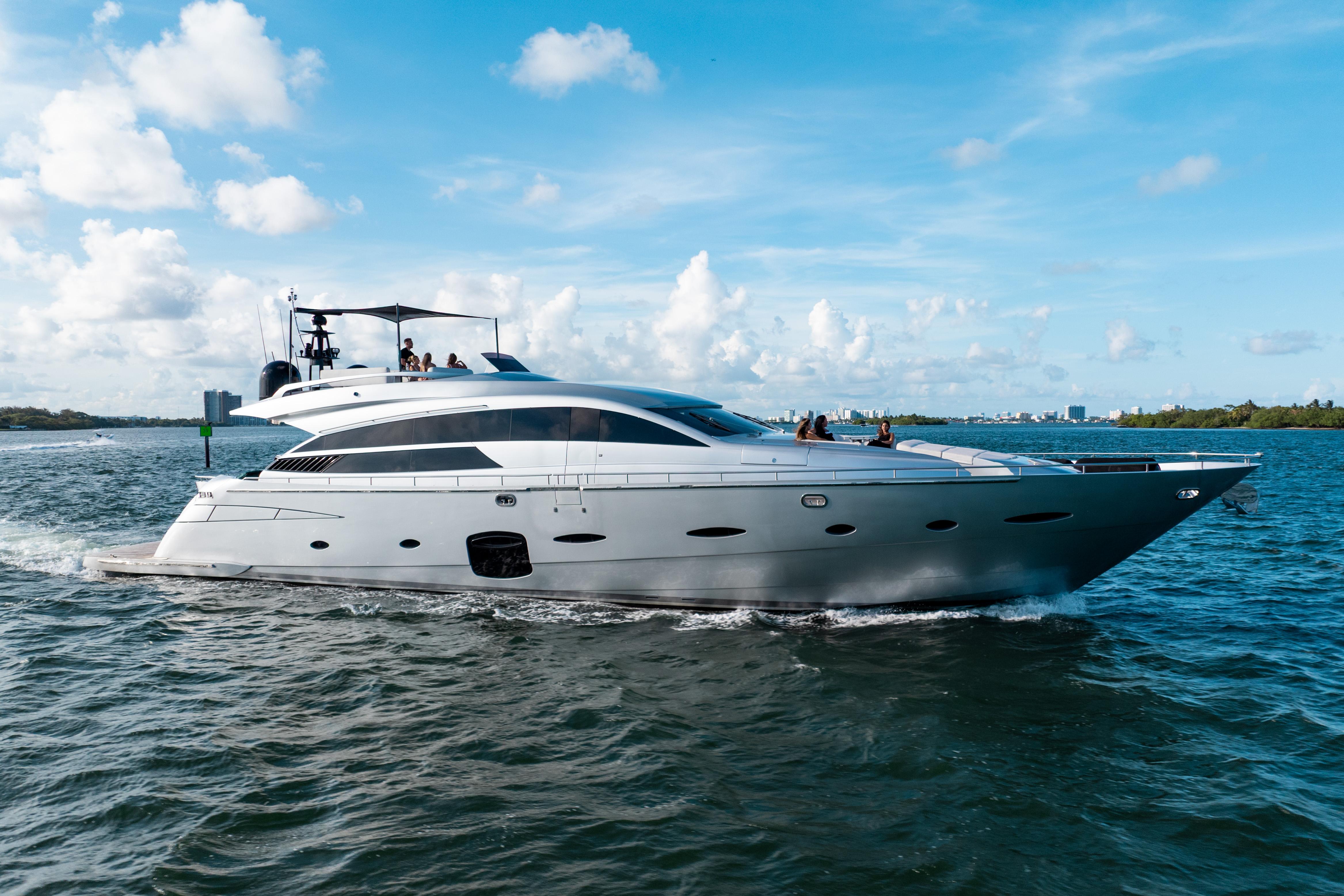 Luxury 2012 Pershing 92 yacht cruising on open water under a clear blue sky.
