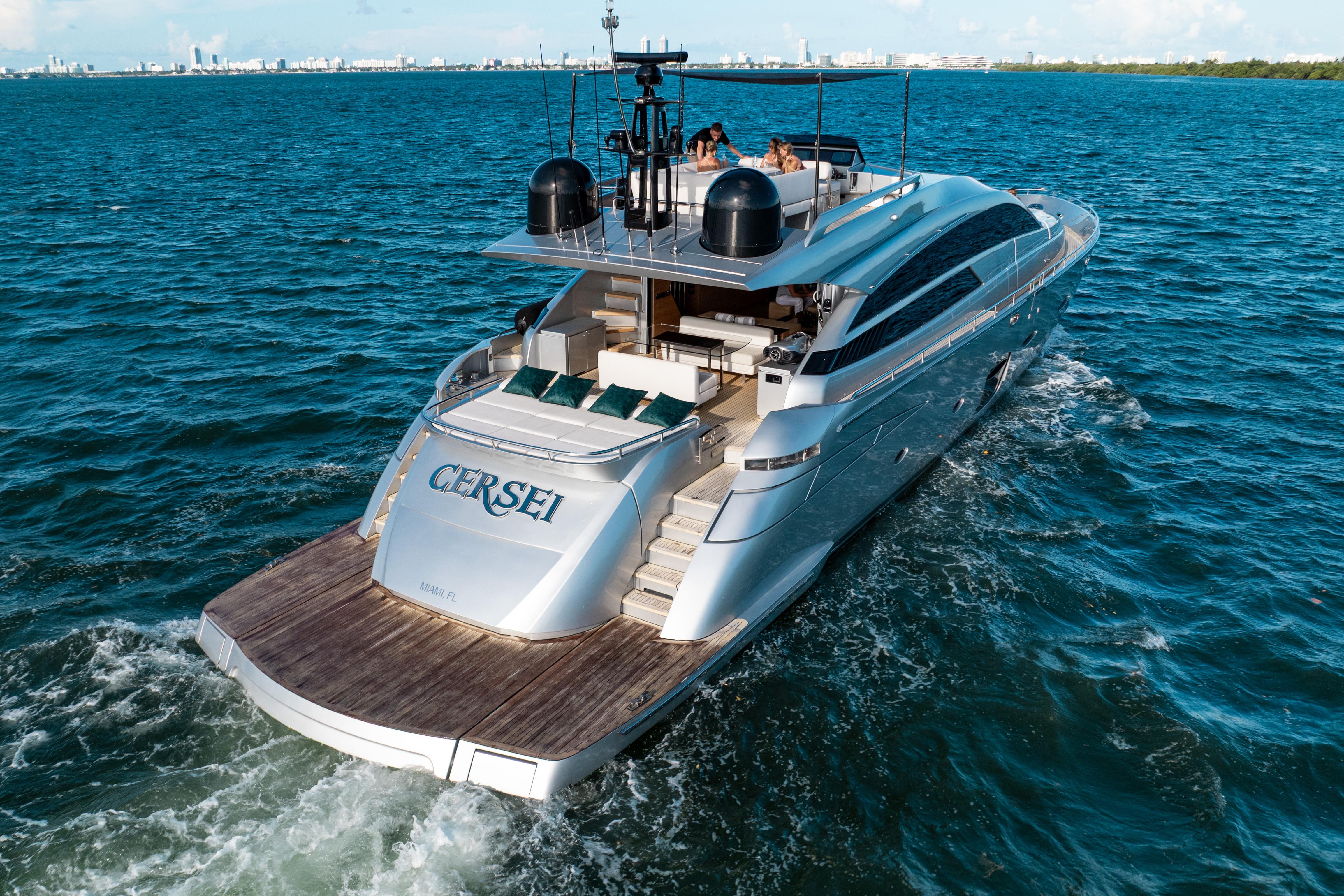 Luxury 2012 Pershing 92 yacht cruising on open water, rear view.