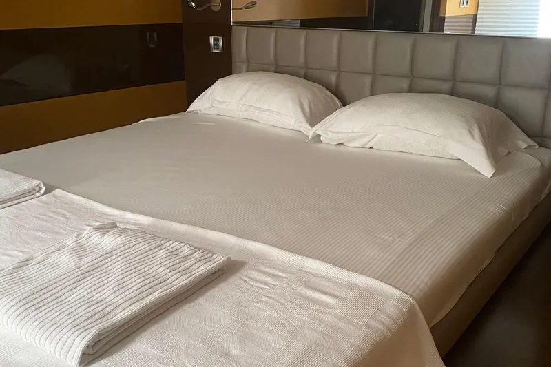  Yacht Photos Pics Luxurious bedroom interior on a 2012 Sunreef 60 yacht, featuring a neatly made bed.