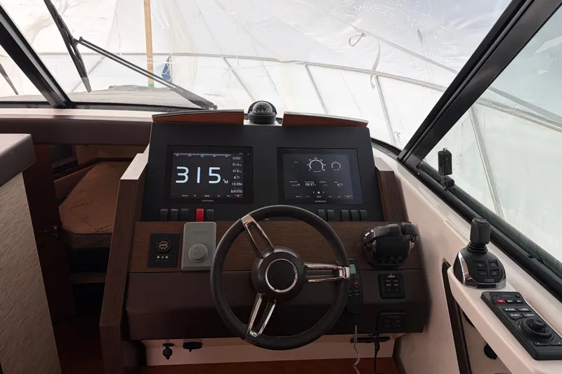  Yacht Photos Pics Cockpit of 2016 Tiara Yachts C44 Coupe with modern navigation displays and controls.