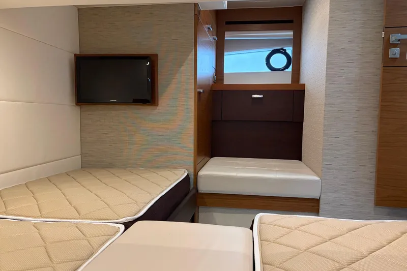  Yacht Photos Pics Interior cabin of 2016 Tiara Yachts C44 Coupe with twin beds and TV.