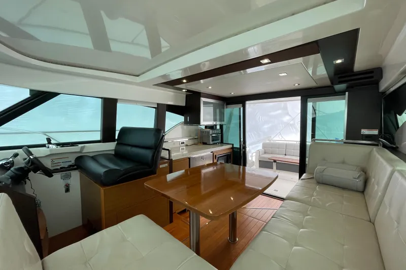  Yacht Photos Pics Luxurious interior of 2016 Tiara Yachts C44 Coupe with modern seating and dining area.