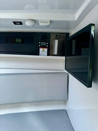  Yacht Photos Pics Interior of 2023 Schaefer 303 Sport boat with control panel and seating.