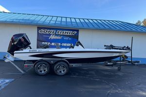 2026 Triton 20XP Patriot boat on trailer at dealership, side view.