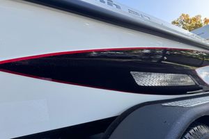 2026 Triton 20XP Patriot boat with sleek red and black detailing.