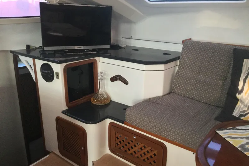 Alleycat Yacht Photos Pics Cozy interior of 2004 Island Spirit 400 yacht with TV and seating area.
