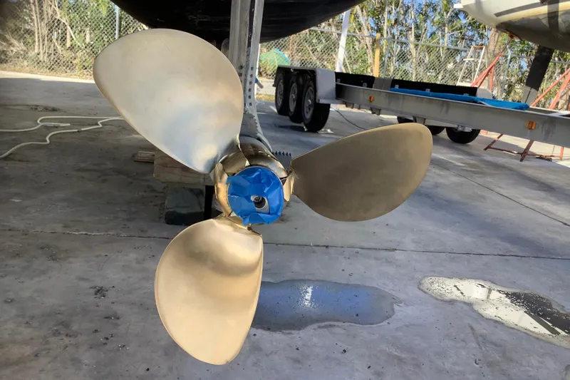 Alleycat Yacht Photos Pics Propeller of 2004 Island Spirit 400 catamaran on dry dock, with blue tape on hub.