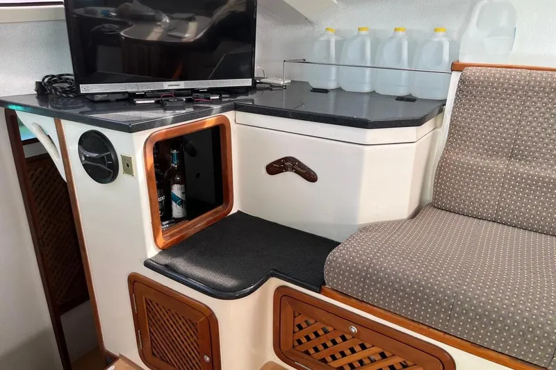 Alleycat Yacht Photos Pics Interior of 2004 Island Spirit 400 yacht with TV, storage, and seating area.