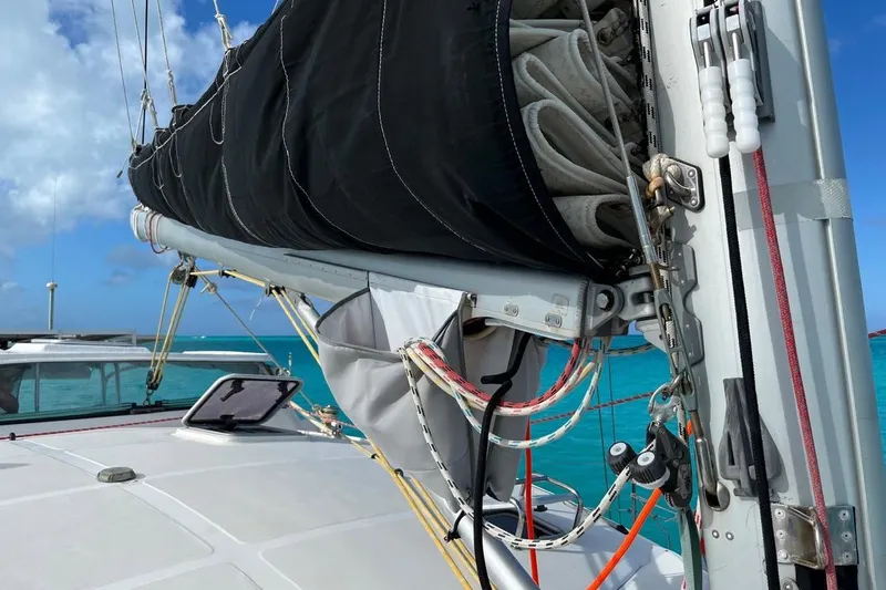 Alleycat Yacht Photos Pics Sailboat Island Spirit 400, 2004 model, with sails furled, on turquoise water background.