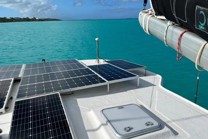 Alleycat Yacht Photos Pics Solar panels on 2004 Island Spirit 400 catamaran, turquoise sea background.