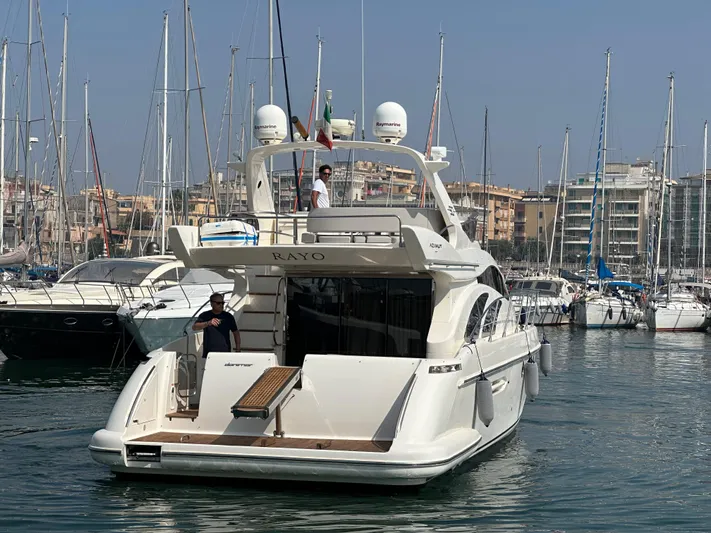 Azimut Benetti Fly 50 Yacht Photos Pics Azimut 50 yacht from 2006 docked in a marina with multiple sailboats.