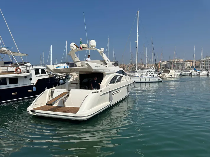 Azimut Benetti Fly 50 Yacht Photos Pics Azimut 50 yacht from 2006 docked in a marina, surrounded by other boats.