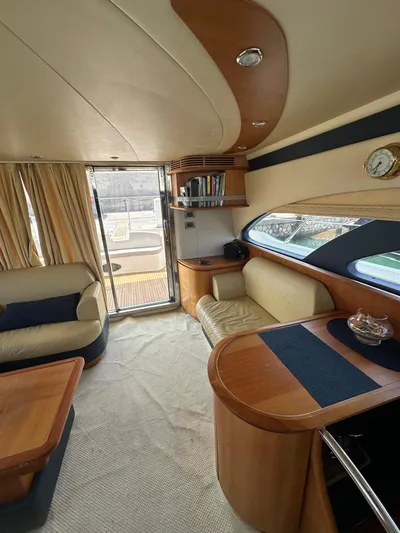 Azimut Benetti Fly 50 Yacht Photos Pics Luxurious interior of a 2006 Azimut 50 yacht with elegant wood finishes and plush seating.