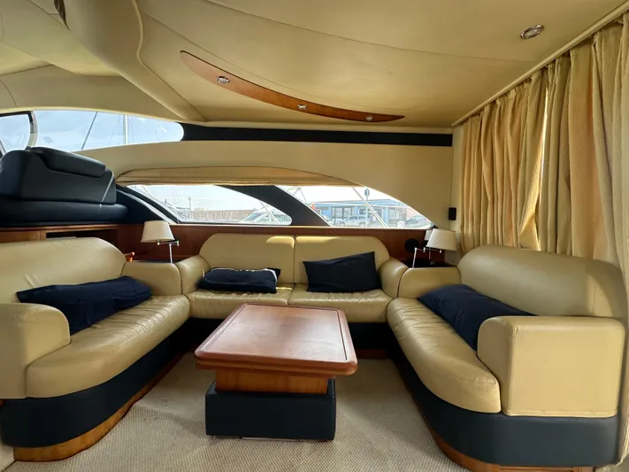 Azimut Benetti Fly 50 Yacht Photos Pics Luxurious interior of a 2006 Azimut 50 yacht with beige leather seating and wooden accents.