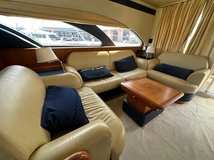 Azimut Benetti Fly 50 Yacht Photos Pics Luxurious interior of a 2006 Azimut 50 yacht with beige leather seating and wooden table.