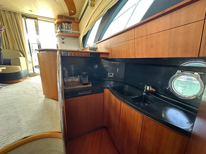 Azimut Benetti Fly 50 Yacht Photos Pics Luxurious interior of a 2006 Azimut 50 yacht with sleek wooden cabinetry and modern amenities.