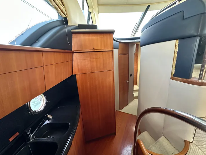 Azimut Benetti Fly 50 Yacht Photos Pics Interior of a 2006 Azimut 50 yacht featuring wood cabinetry and modern design elements.