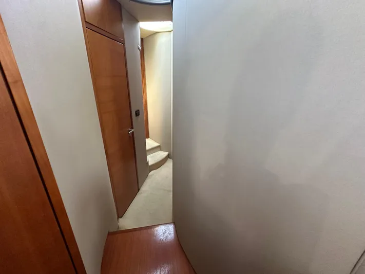 Azimut Benetti Fly 50 Yacht Photos Pics Hallway inside 2006 Azimut 50 yacht with wooden doors and carpeted stairs.
