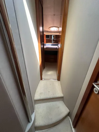 Azimut Benetti Fly 50 Yacht Photos Pics Interior hallway of 2006 Azimut 50 yacht with carpeted steps and wooden accents.