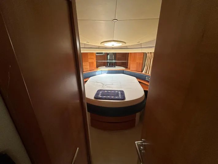 Azimut Benetti Fly 50 Yacht Photos Pics Luxurious cabin interior of 2006 Azimut 50 yacht with circular bed and wooden accents.