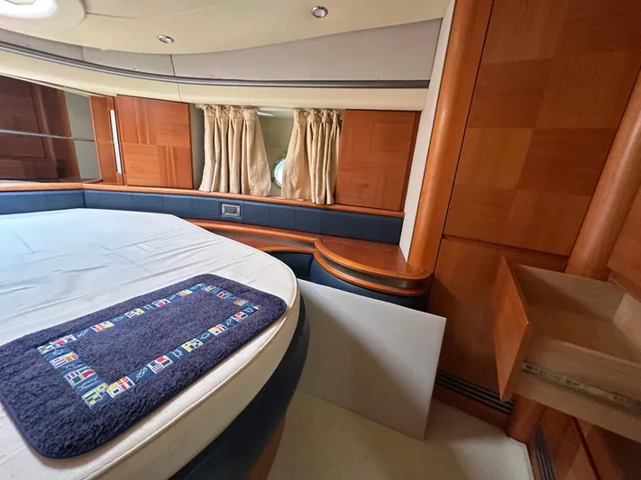 Azimut Benetti Fly 50 Yacht Photos Pics Luxurious cabin interior of a 2006 Azimut 50 yacht with wood paneling and a cozy bed.