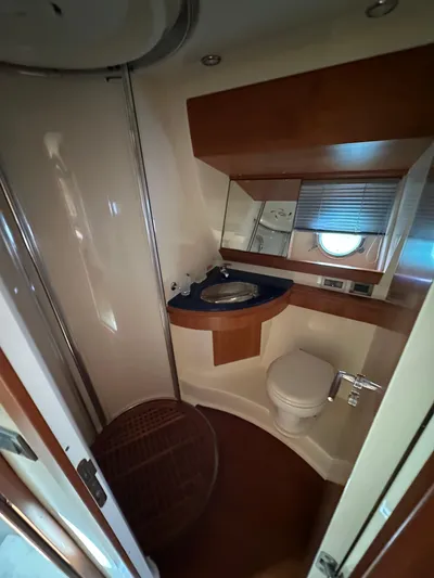 Azimut Benetti Fly 50 Yacht Photos Pics Bathroom interior of a 2006 Azimut 50 yacht, featuring modern fixtures and wood accents.