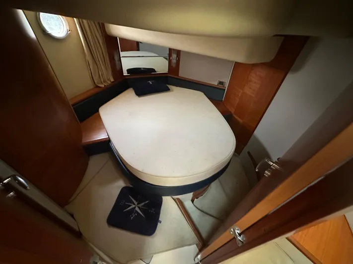 Azimut Benetti Fly 50 Yacht Photos Pics Interior cabin of a 2006 Azimut 50 yacht with a cozy bed and wooden accents.