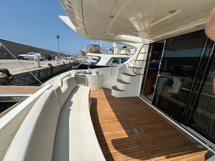 Azimut Benetti Fly 50 Yacht Photos Pics Azimut 50 yacht deck, 2006 model, featuring elegant seating and wooden flooring.