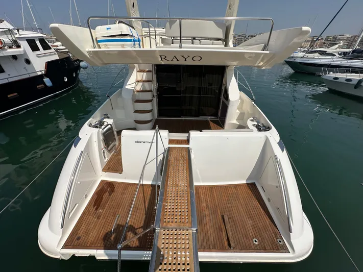 Azimut Benetti Fly 50 Yacht Photos Pics 2006 Azimut 50 yacht with wooden deck, docked in a marina.