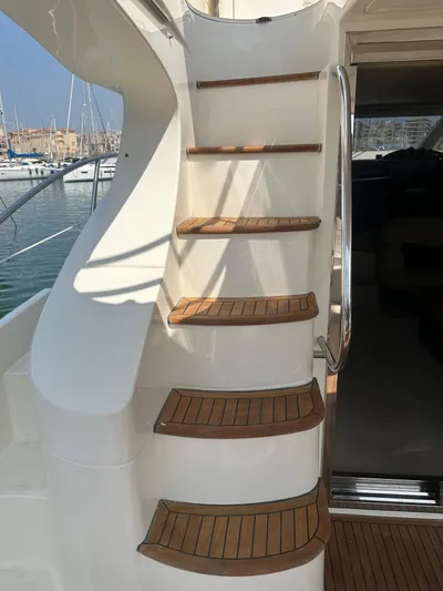 Azimut Benetti Fly 50 Yacht Photos Pics Staircase on 2006 Azimut 50 yacht with wooden steps, docked at marina.