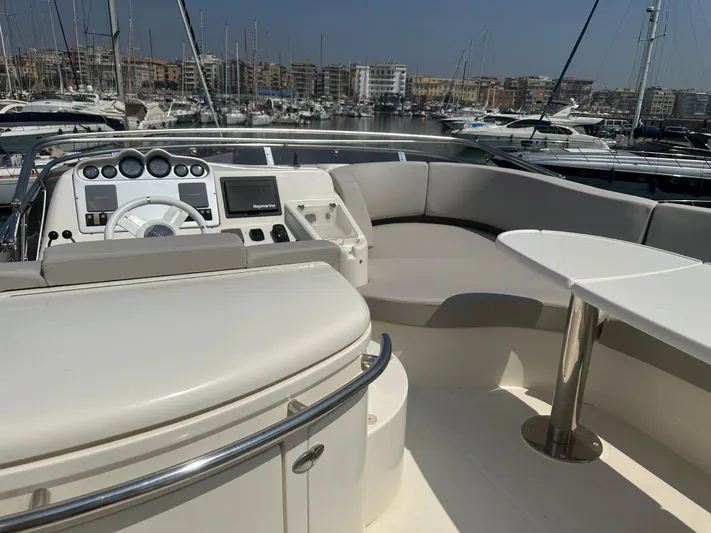 Azimut Benetti Fly 50 Yacht Photos Pics Flybridge of 2006 Azimut 50 yacht with seating and control panel, docked in marina.