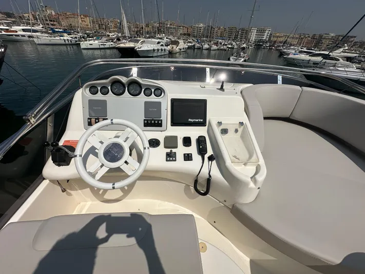 Azimut Benetti Fly 50 Yacht Photos Pics Helm of 2006 Azimut 50 yacht with steering wheel and navigation controls.