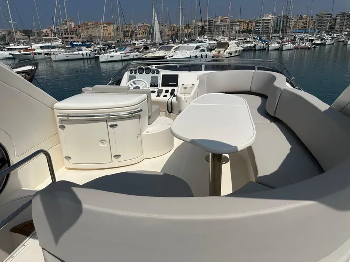 Azimut Benetti Fly 50 Yacht Photos Pics Flybridge of 2006 Azimut 50 yacht with seating and control panel, docked in marina.