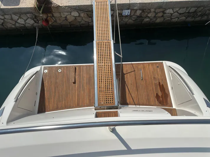 Azimut Benetti Fly 50 Yacht Photos Pics 2006 Azimut 50 yacht stern with wooden deck and gangway in marina.